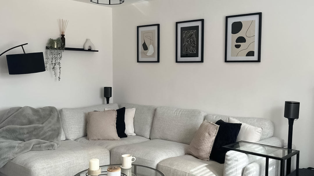 3 piece beige abstract wall prints on living room wall.