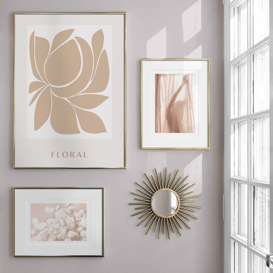 Beige and white canvas gallery on wall by window.