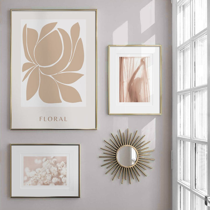 Beige and white canvas gallery on wall by window.