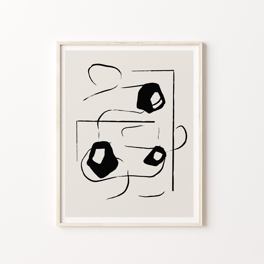Black and beige abstract poster in frame.