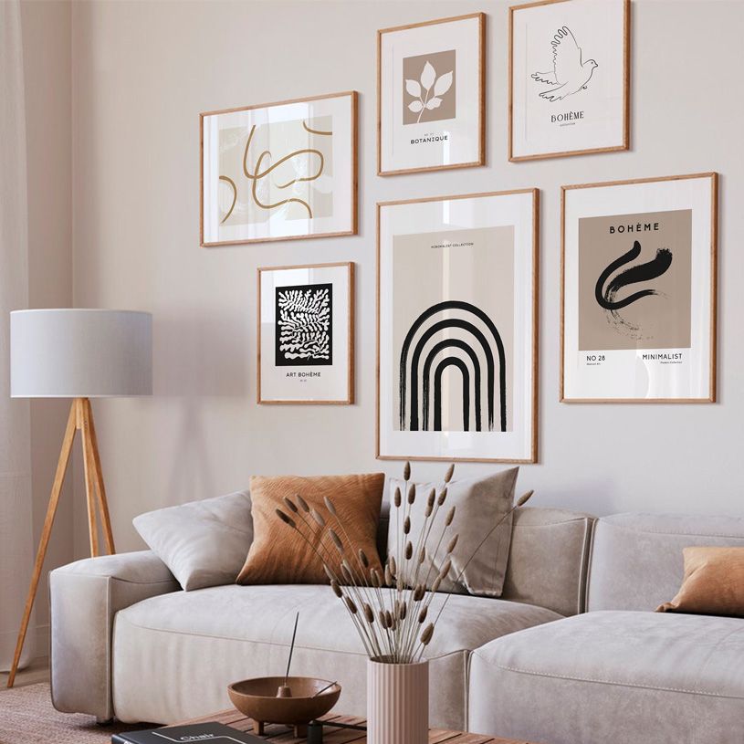 Black and beige abstract wall art on beige living room wall.
