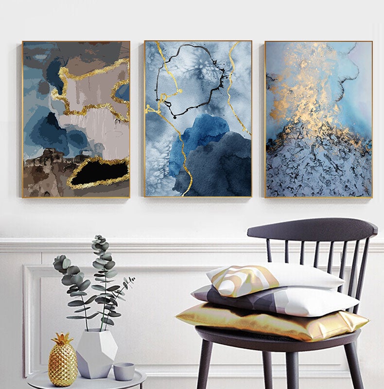 Blue and gold set of 3 on white wall.