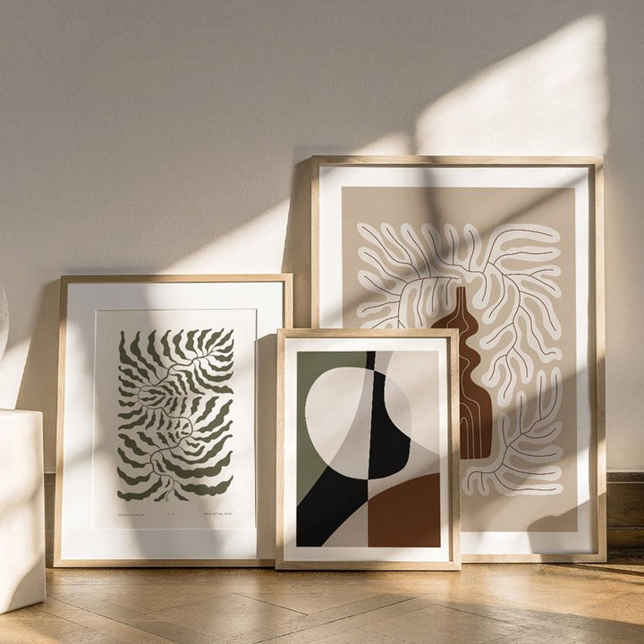 Abstract canvas poster set framed, leaning up against wall.
