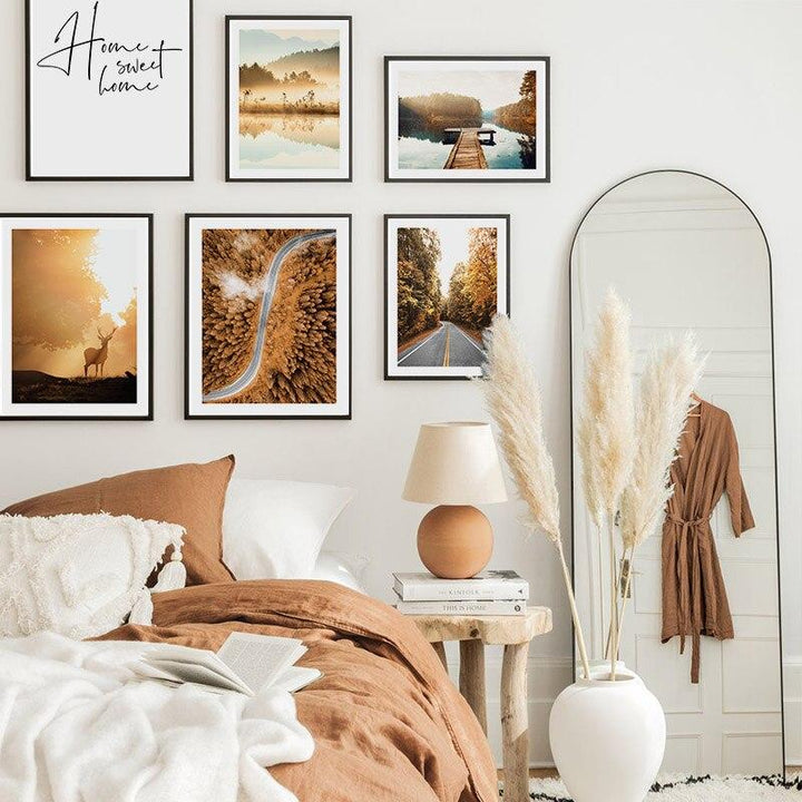 Nature poster gallery set on bedroom wall above bed.