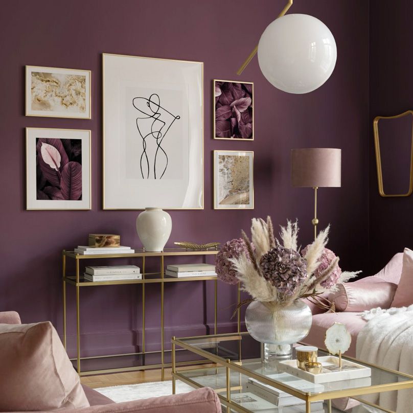 Purple wall art set on living room wall.