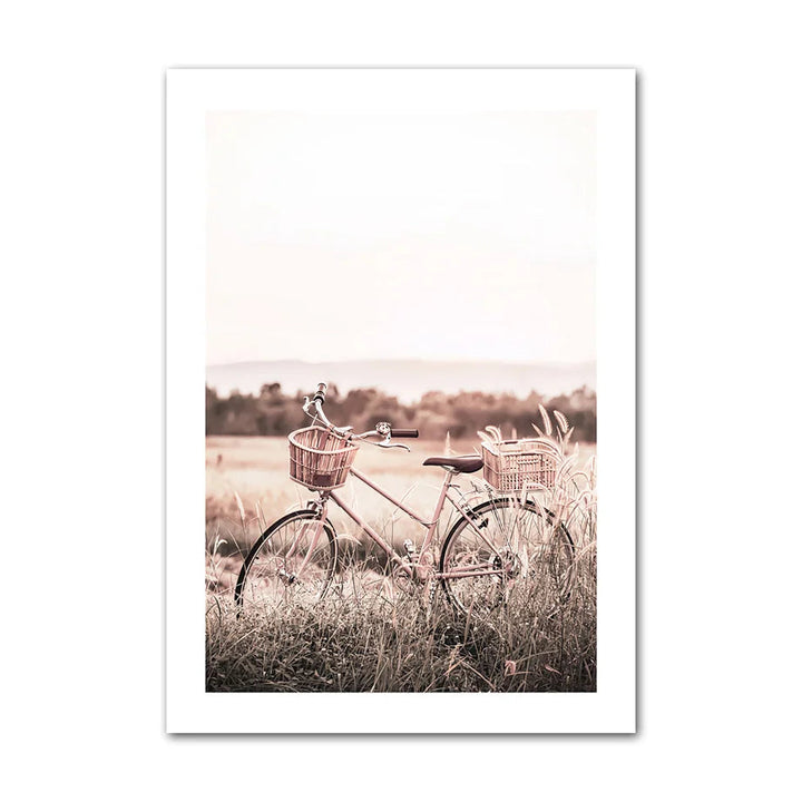 Sepia-toned bicycle with baskets in a field on a white background