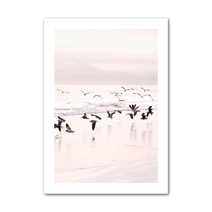 Canvas print with birds flying over water at sunset.