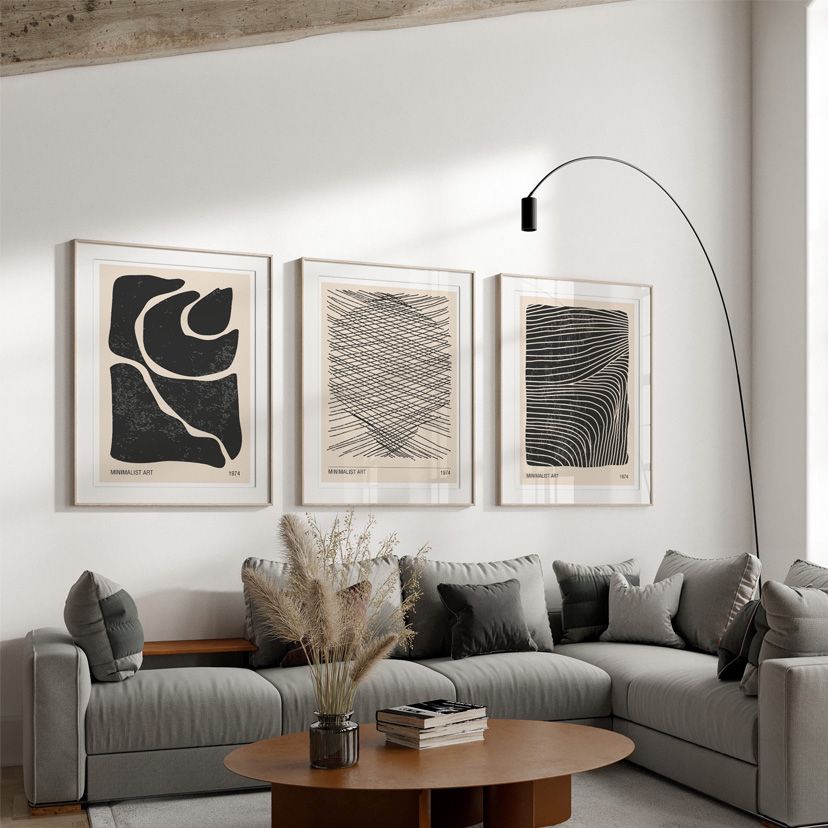 Black and beige wall art set of 3 on living room wall.