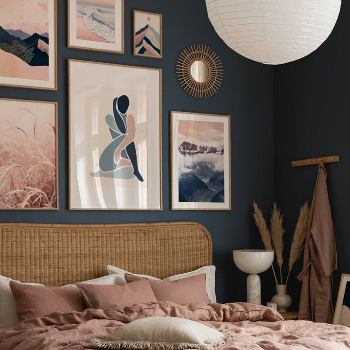 Blue and pink abstract wall art set on bedroom wall.