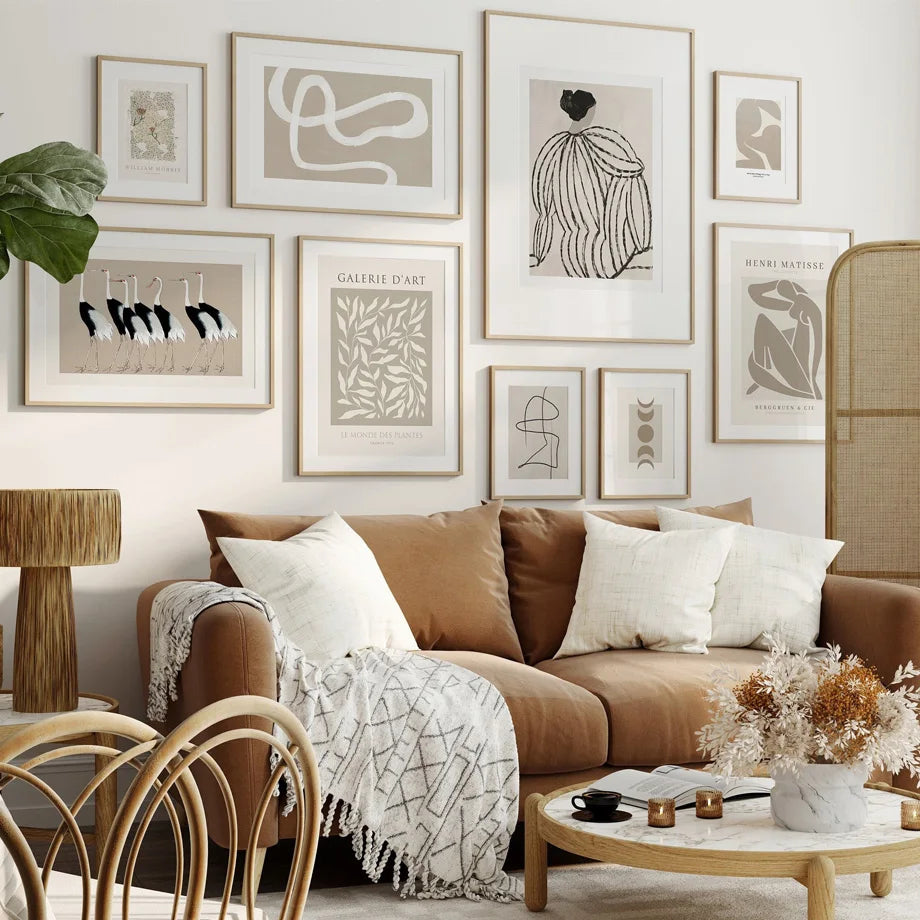 Fawn and cream wall art set on white living room wall.