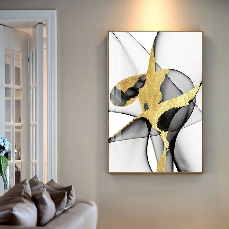Gold and black abstract poster on beige living room wall.