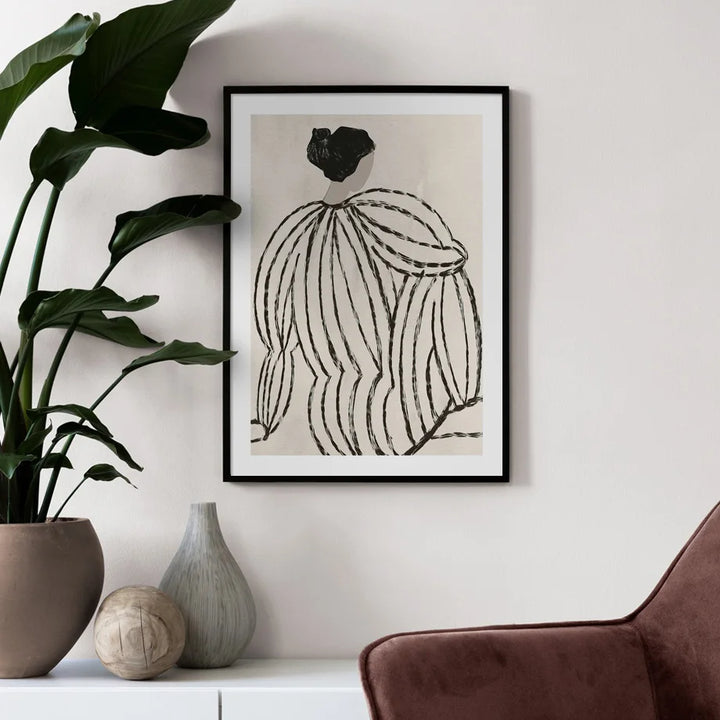 Minimal style print of women sitting on wall in living room.