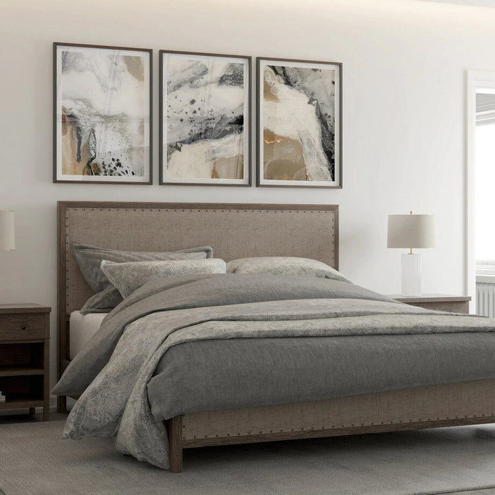 Neutral abstract wall art set above bed.