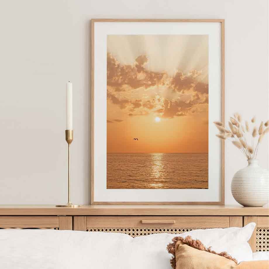 Orange sunset canvas poster on bedroom wall.