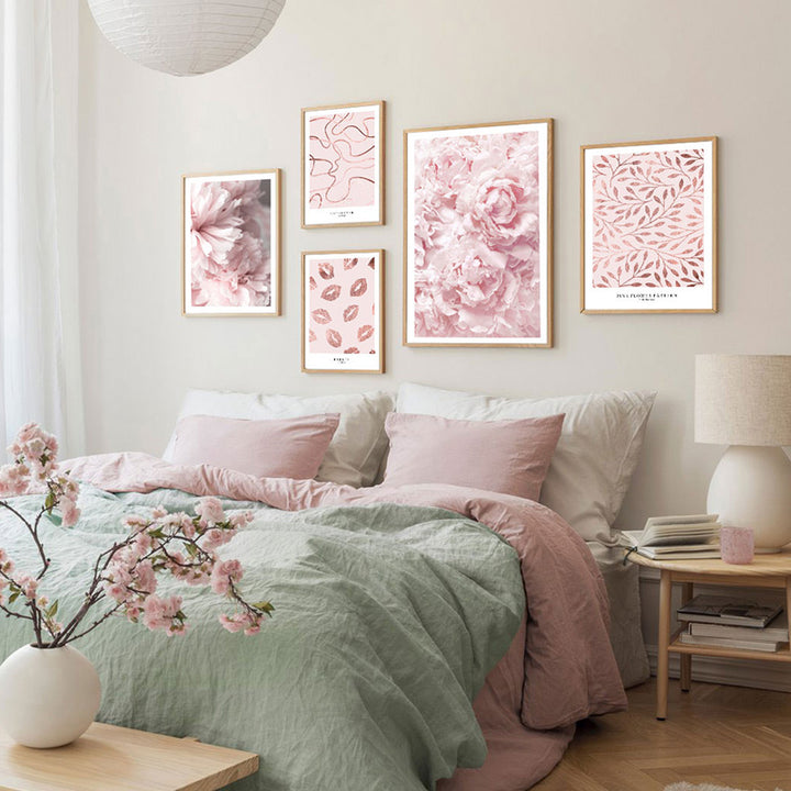 Pink and gold wall art set in bedroom.