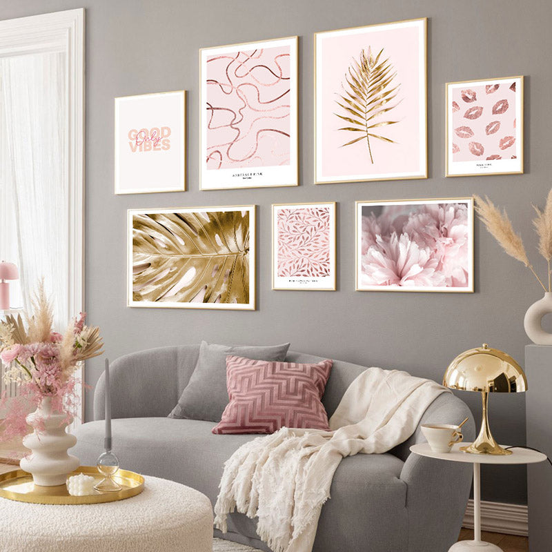 Pink and gold wall art set in living room.