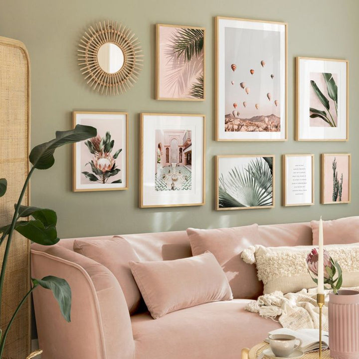 Pink and green art prints on wall.