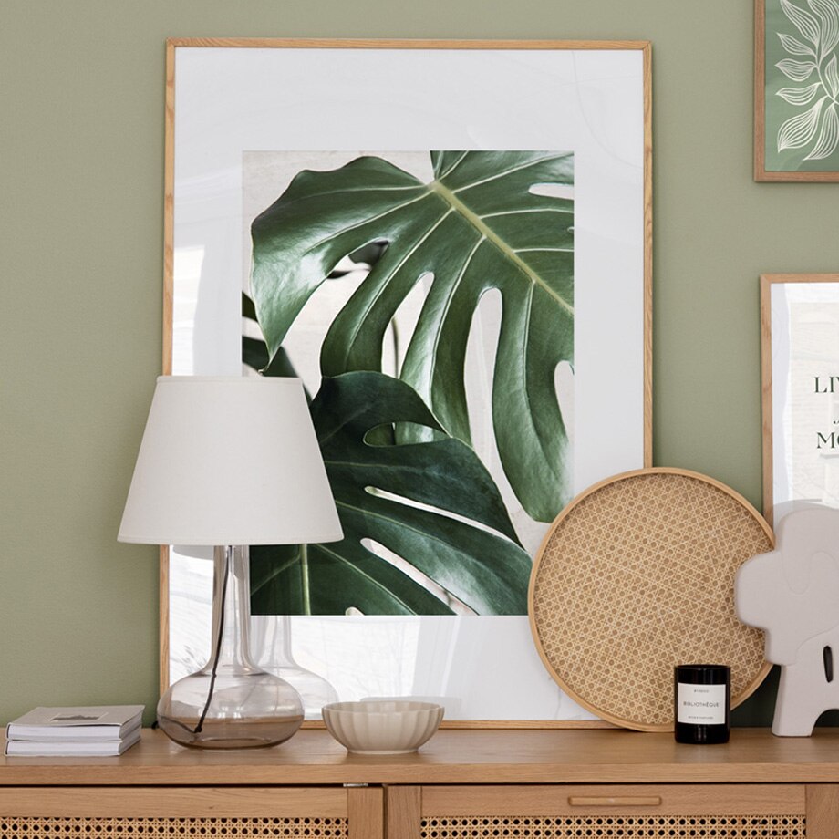 Plant poster in frame on sideboard.
