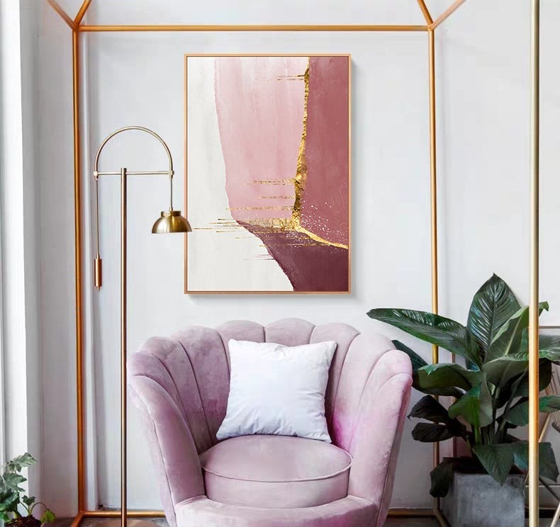 Pink and gold abstract poster on wall.
