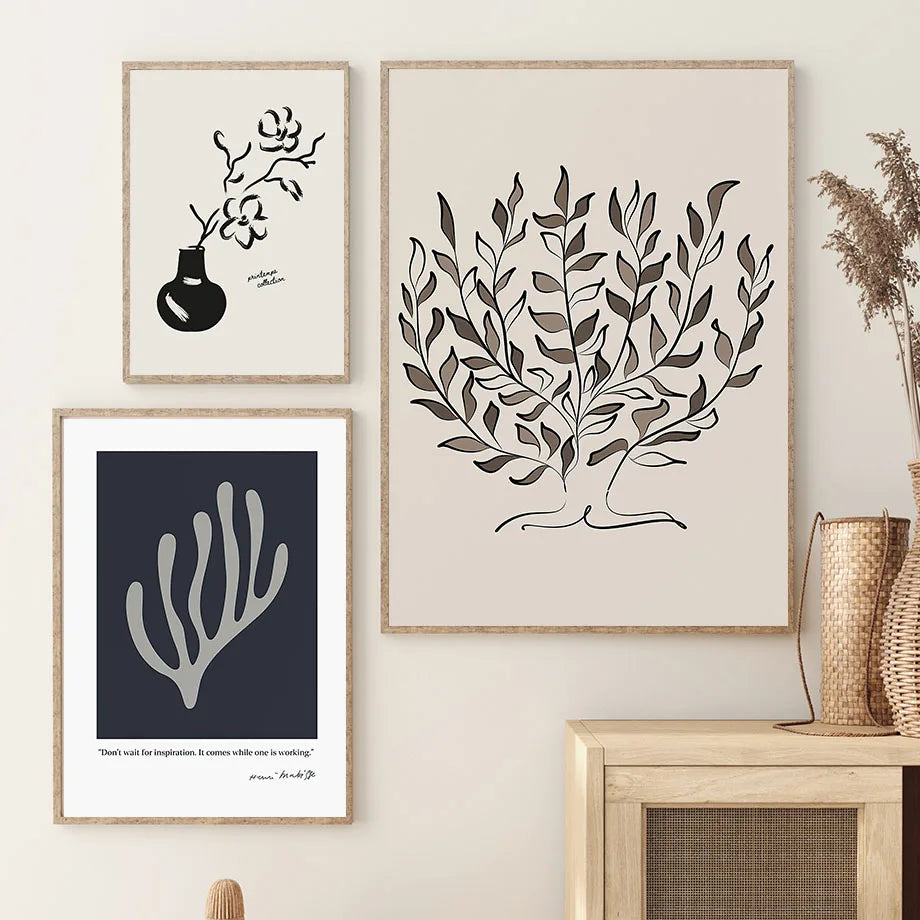 Olive tree, navy leaf and magnolia vase canvas prints above a rattan sideboard