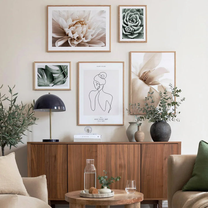 Living room with wooden sideboard, decorative plants, and framed artwork on a wall.