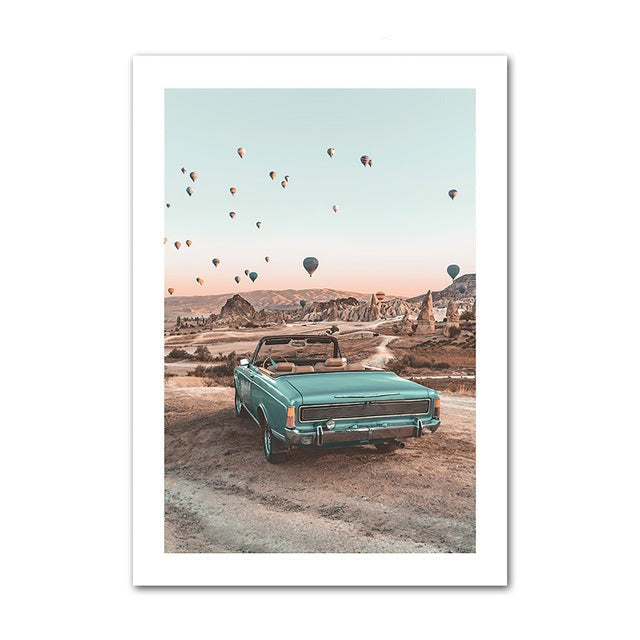 Automobile in canyon view with hot air balloon  in background poster.