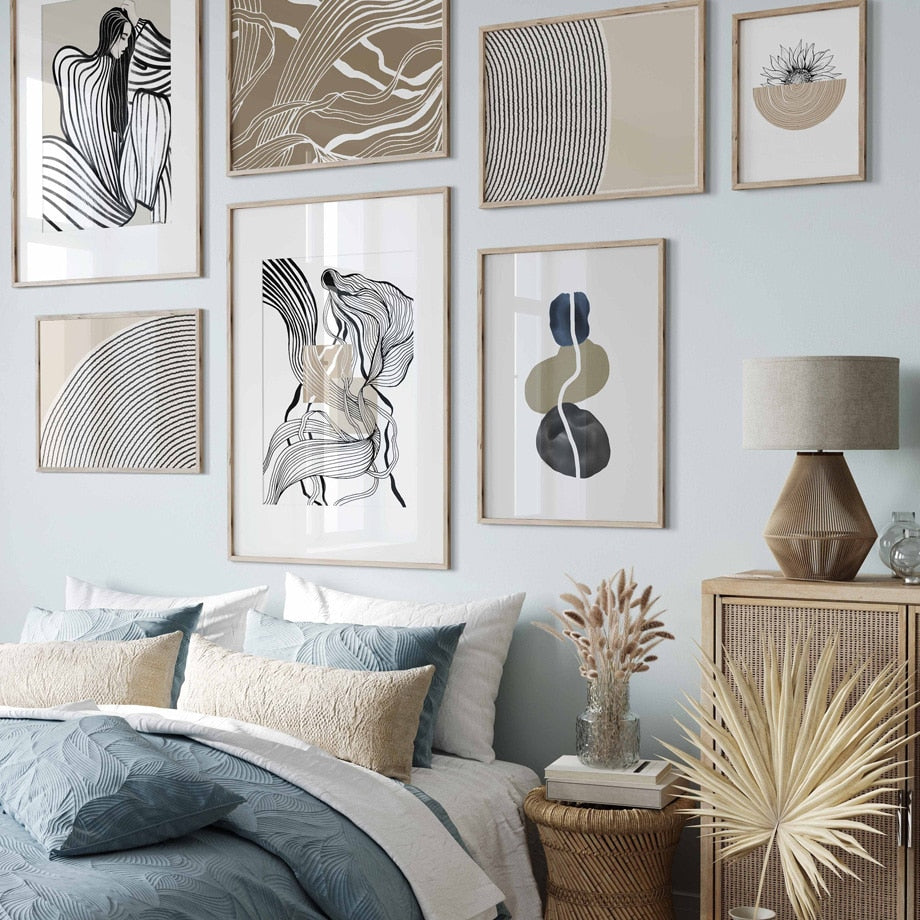 Beige and black abstract wall art set on blue bedroom wall.