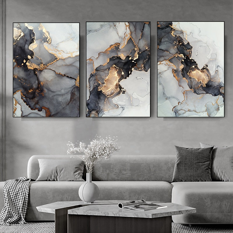 Black and gold 3 piece gallery on living room wall.