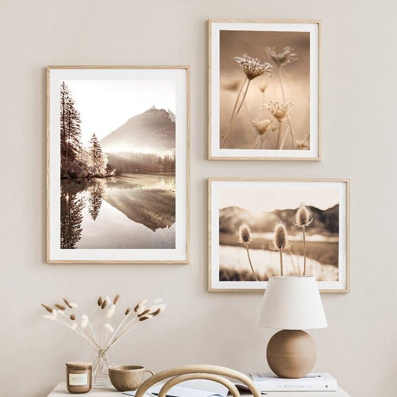 3 nature canvas prints on beige wall above bed.