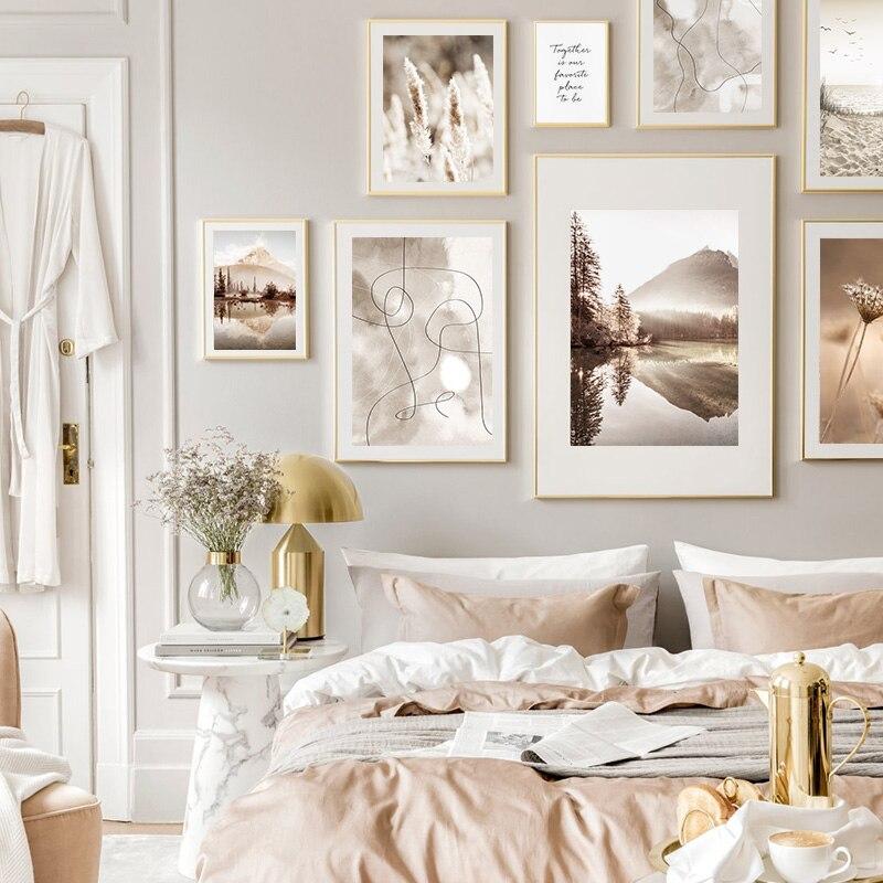 Dreamy nature canvas posters on bedroom wall above bed.