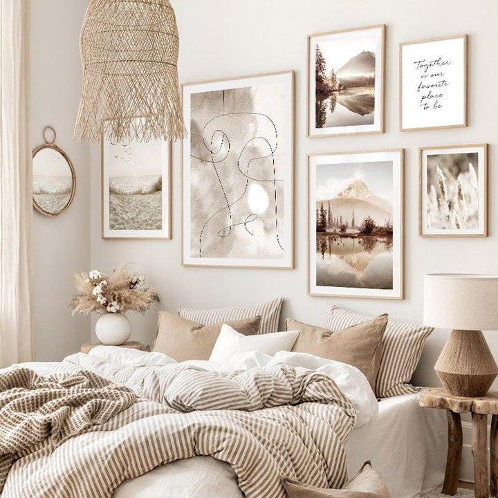 Dreamy beige wall art gallery on bedroom wall above bed.
