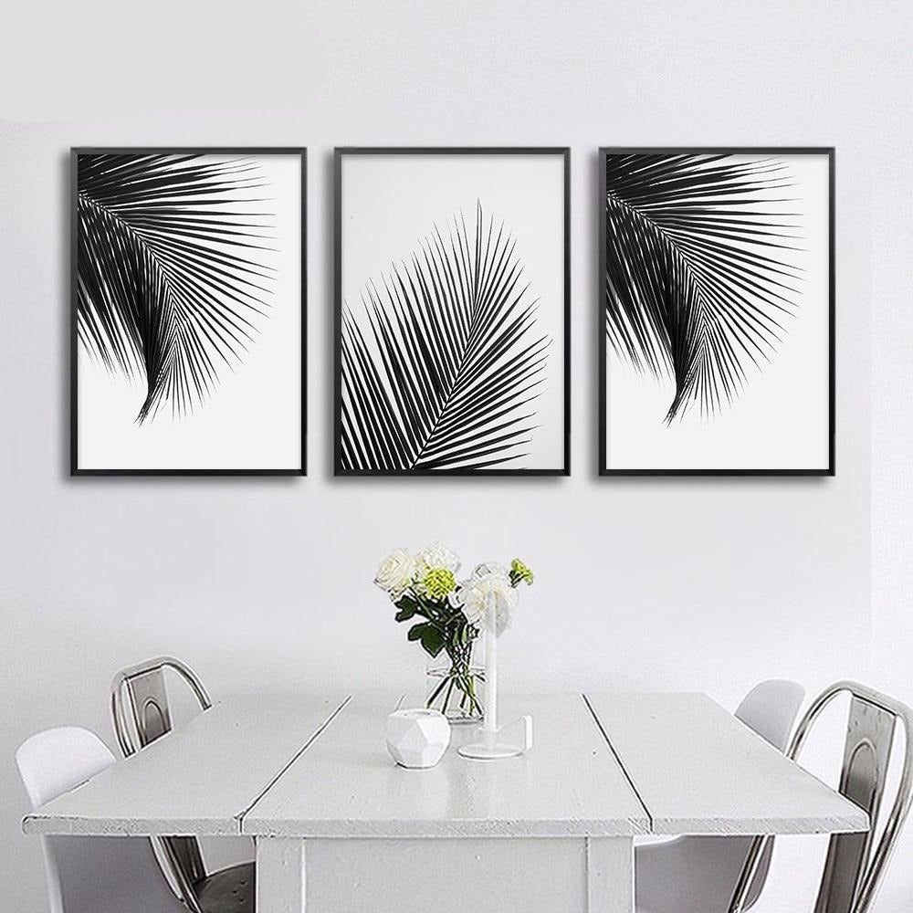 Black and white wall art set on dining room wall.