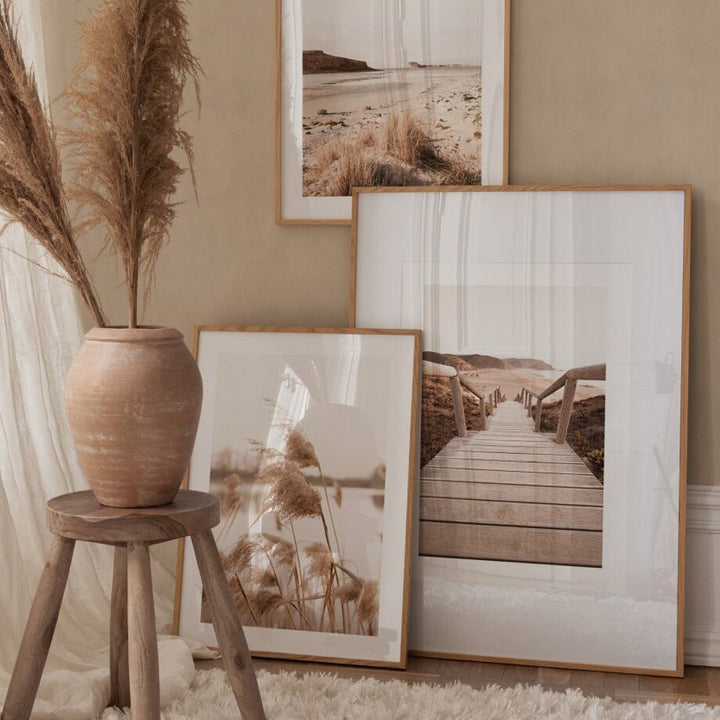 Nature photography framed prints on living room floor.