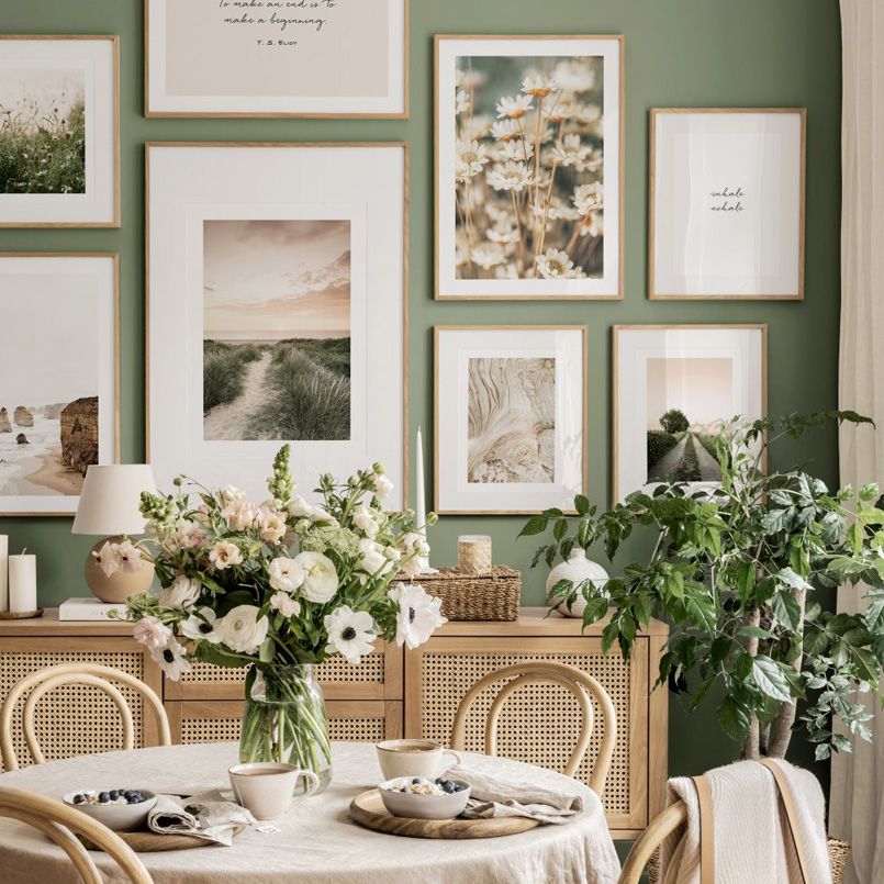 Nature photography wall set on green dining room wall.