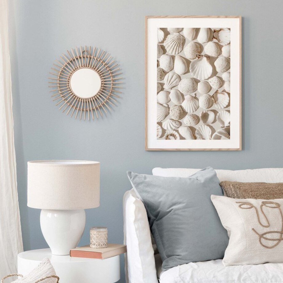 Seashells poster on blue living room wall.